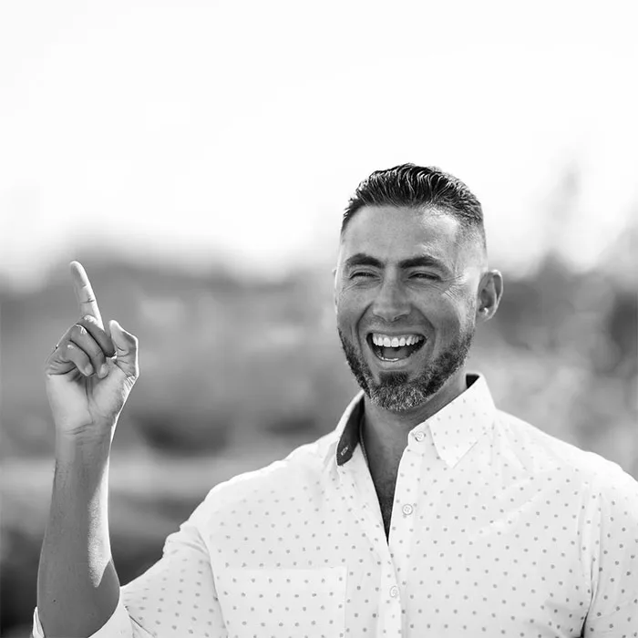 Brian Ballah laughing, pointing upward